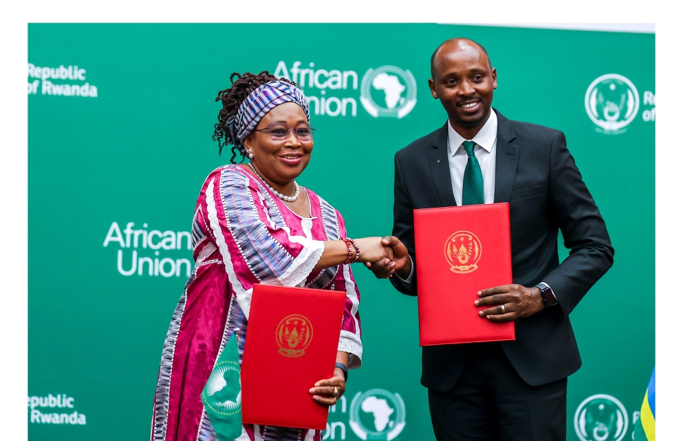 Health Minister Dr. Sabin Nsanzimana and the AU Commissioner for Health, Humanitarian Affairs, and Social Development, Minata Samate Cessouma  exchange documents during the signing ceremony in Kigali on Saturday, June 10. Photo by Olivier Mugwiza