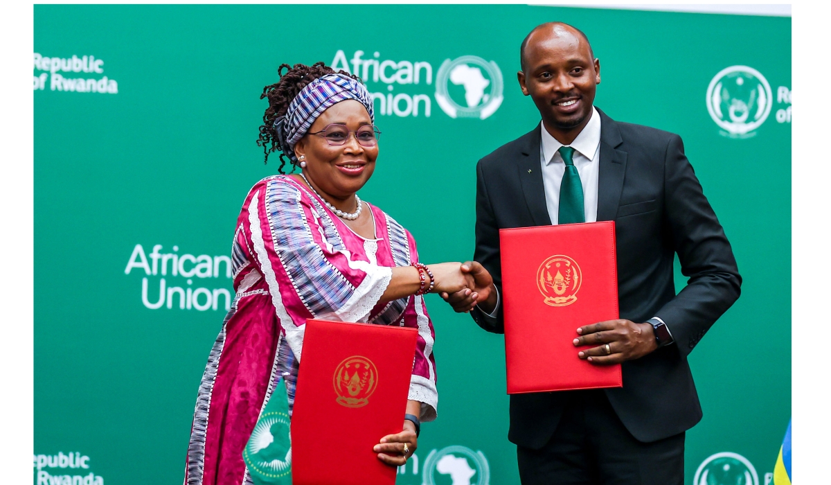 Health Minister Dr. Sabin Nsanzimana and the AU Commissioner for Health, Humanitarian Affairs, and Social Development, Minata Samate Cessouma  exchange documents during the signing ceremony in Kigali on Saturday, June 10. Photo by Olivier Mugwiza