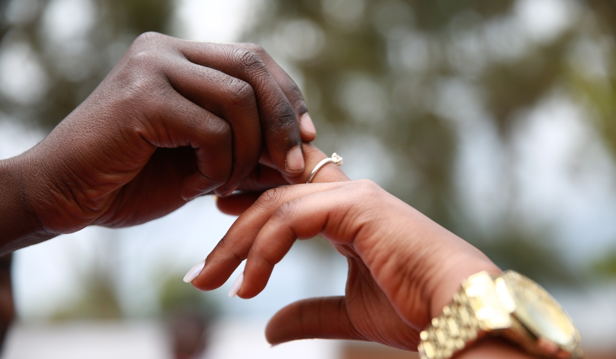 A bride and groom during a wedding ceremony. Sam Ngendahimana