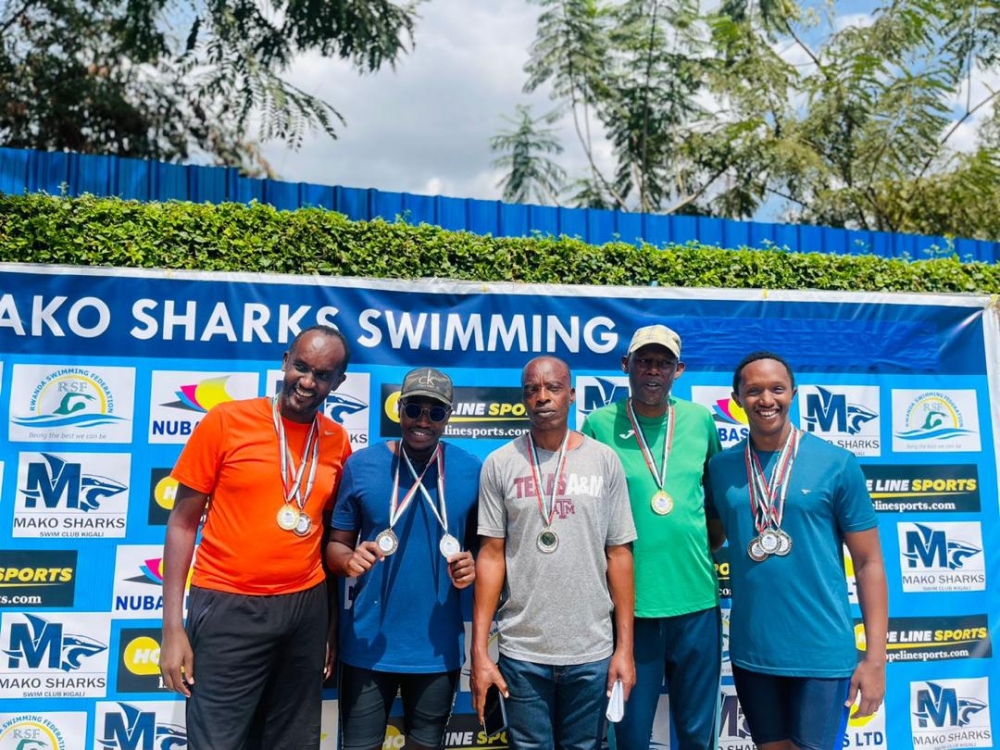 Hirwa (2nd left) poses for a photo alongside other winners after bagging two medals at the just-concluded Mako Sharks masters&#039; swimming contest-courtesy