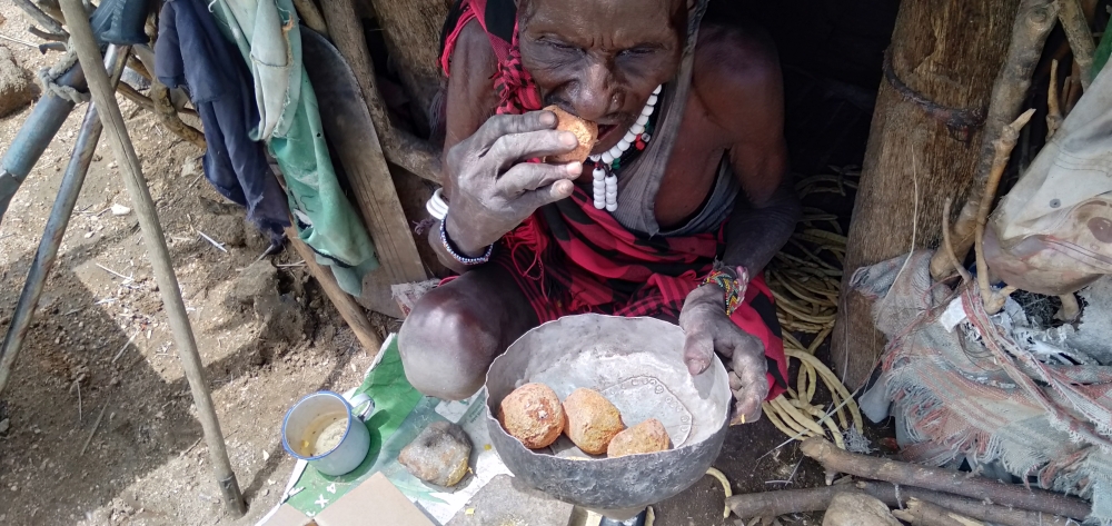 An elderly man struggles to squeeze some juice from a wild fruit in Turkana County, Kenya in this March 2023 photo. Effects of climate change receive
little coverage in African newsrooms leading to limited knowledge which affects mitigation activities. Photos: Njenga Hakeenah.
