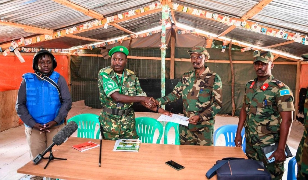 Atmis Burundi National Defence Forces Commander of the Forward Operating Base (FOB) Lt Col Richard Binyenimana (L) shakes hands with Somalia National Army Commander Maj Gen Bashir Abukar Ahmed during the handing over Xaaji Cali FOB in Hirshabelle State in Somalia on June 20, 2023. PHOTO | ATMIS