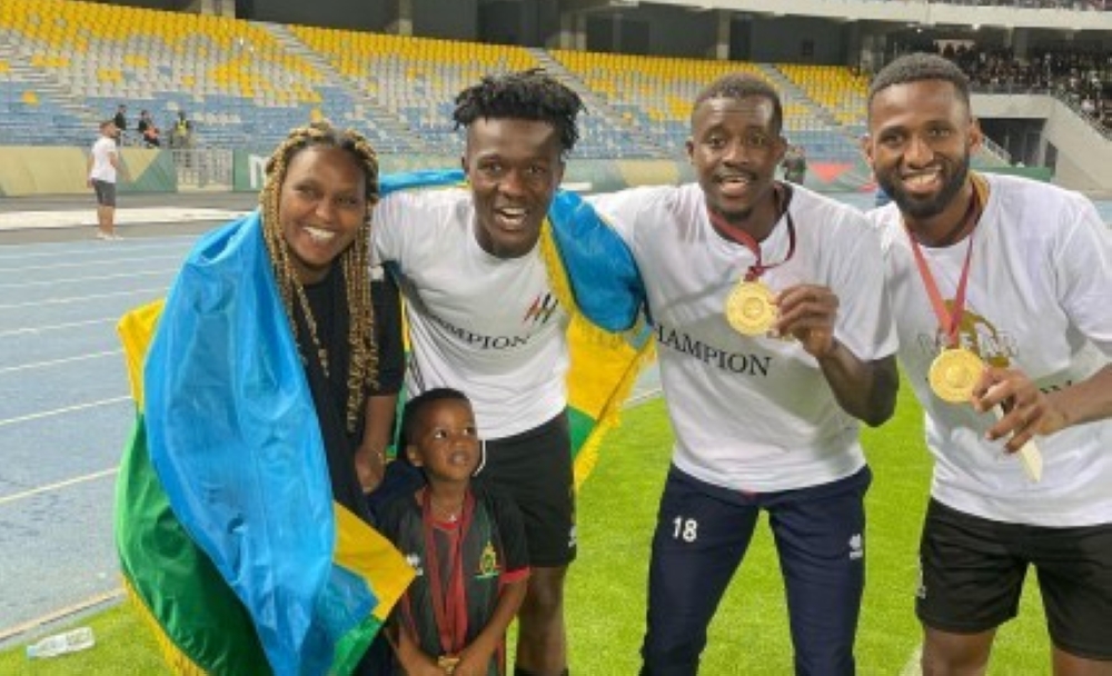 Defender Emmanuel Imanishimwe (C) celebrates with his family and some teammates helping AS FAR Rabat to win their first league title since 2008. Courtesy.