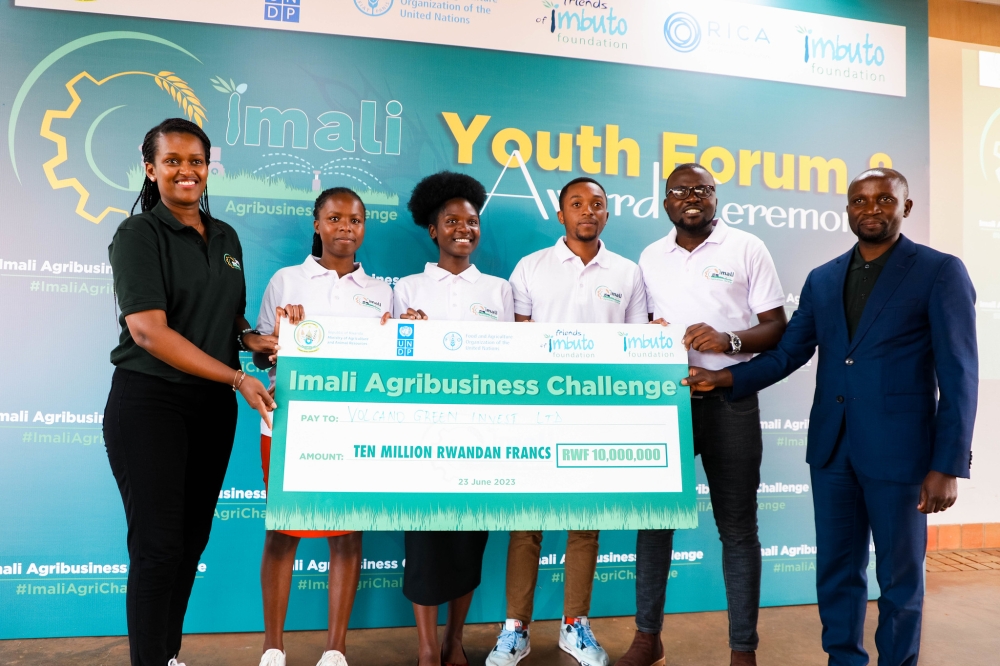 The Minister of Agriculture, Ildephonse Musafiri and the Director General of Imbuto Foundation, Sandrine Umutoni award one  group during the awarding ceremony of the 15 young agripreneurs in Bugesera on Friday, June 23. All photos by Craish Bahizi