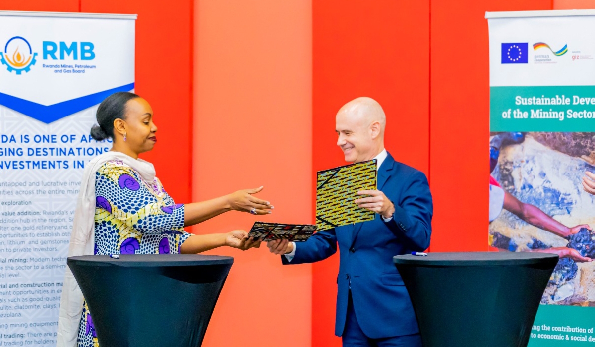 Yamina Karitanyi, Chief Executive Officer of the Rwanda Mines, Petroleum, and Gas Board and Martin Kraft, GIZ Country Director exchange documents during the signing of the agreement in Kigali on Monday, June 26. Courtesy