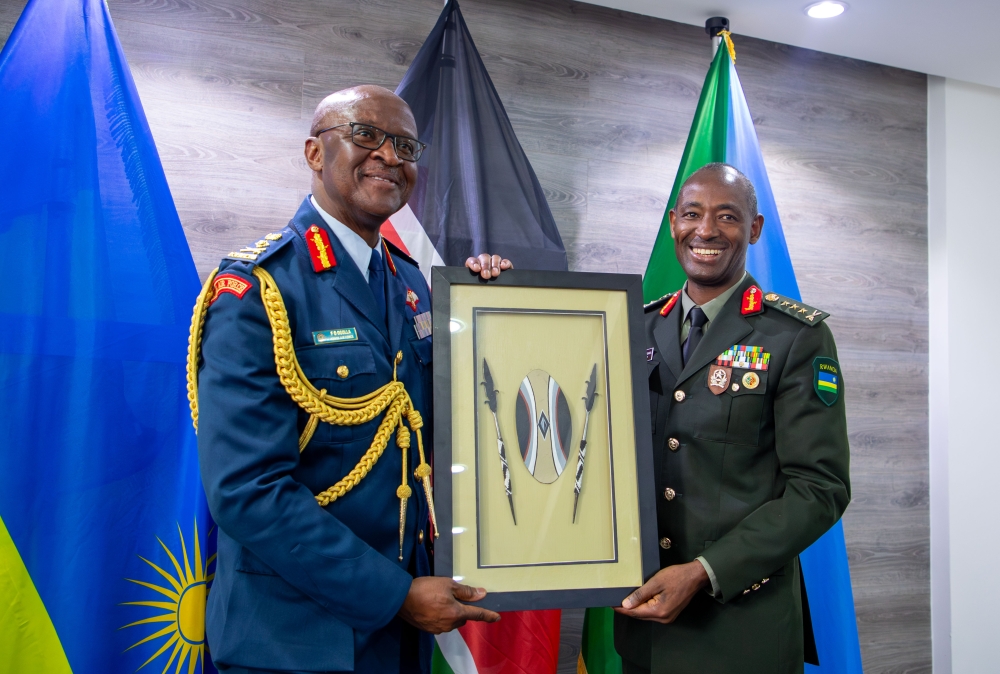 Gen Muganga giving Gen Ogolla a gift