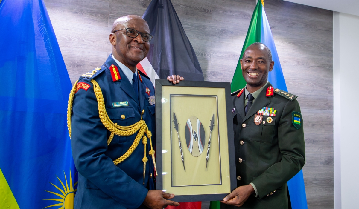 Gen Muganga giving Gen Ogolla a gift