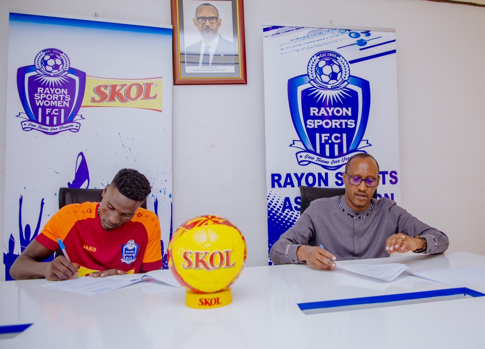 Rayon Sports president Fidel Uwayezu and goalkeeper Simon Tamale as Tamale signs a   two-year deal with the Blues. Courtesy