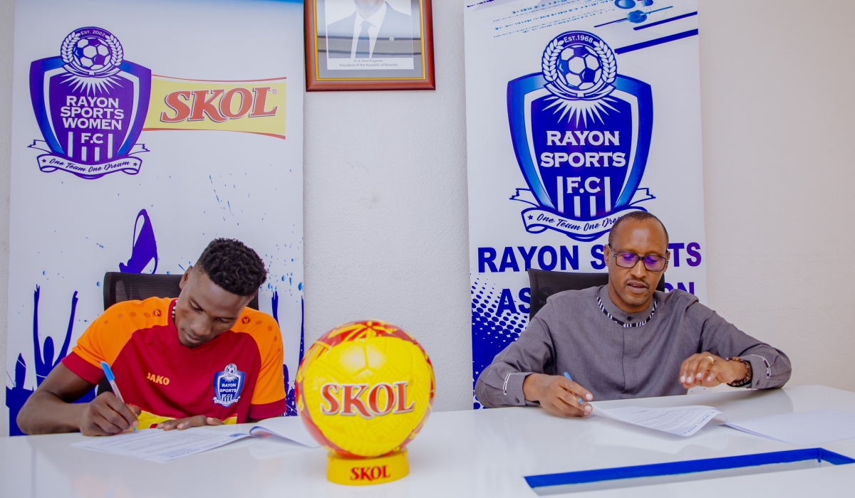 Rayon Sports president Fidel Uwayezu and goalkeeper Simon Tamale as Tamale signs a   two-year deal with the Blues. Courtesy