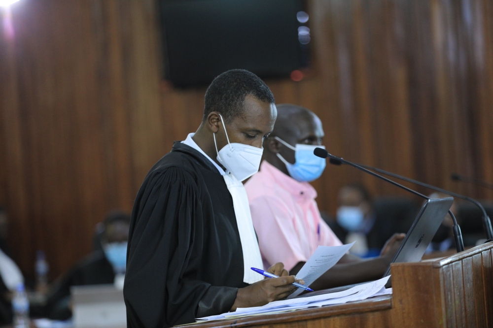 A lawyer assists his client during a hearing session at FLN trial in Kigali on May 7, 2021. Sam Ngendahimana