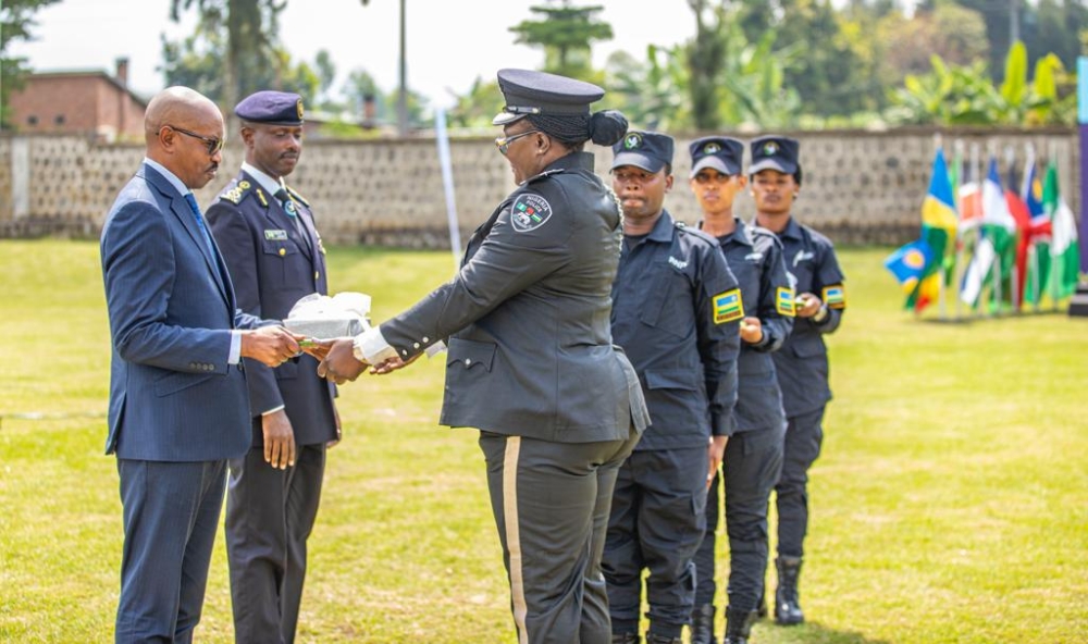 The Minister of Interior, Alfred Gasana awarding SP Tolulope Aderonke Ipinmisho from Nigeria for Best College Research Paper.