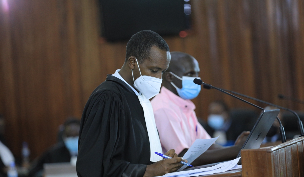 A lawyer assists his client during a hearing session at FLN trial in Kigali on May 7, 2021. Sam Ngendahimana