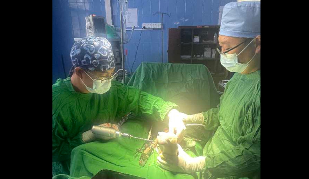Dr. Lidong Yu, a Chinese orthopedic surgeon  and his teammate during a surgical operation at Kibungo Referral Hospital in Rwanda. Courtesy