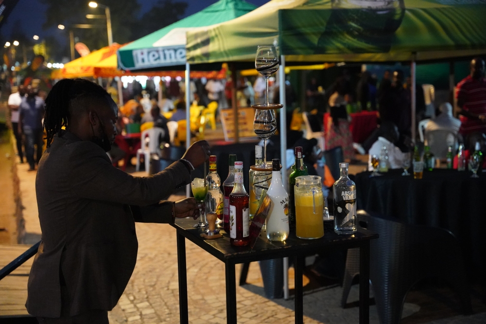A waiter sets a mini-bar at Gisimenti Car Free Zone. Craish Bahizi