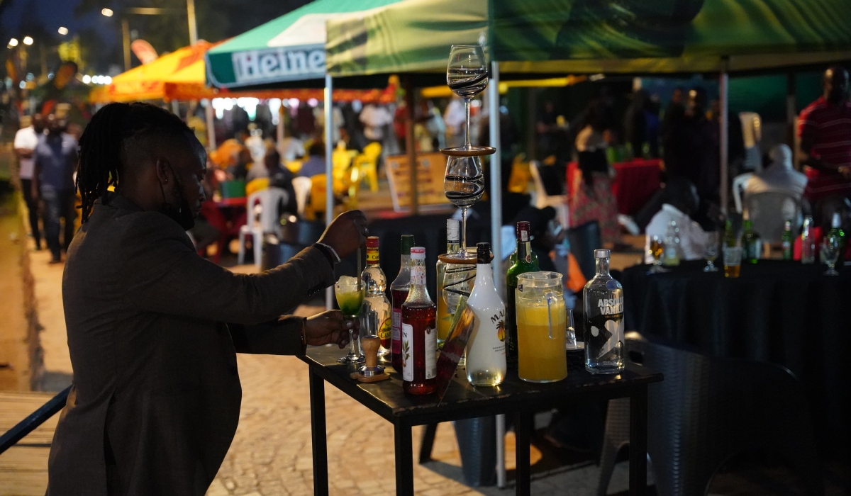 A waiter sets a mini-bar at Gisimenti Car Free Zone. Craish Bahizi