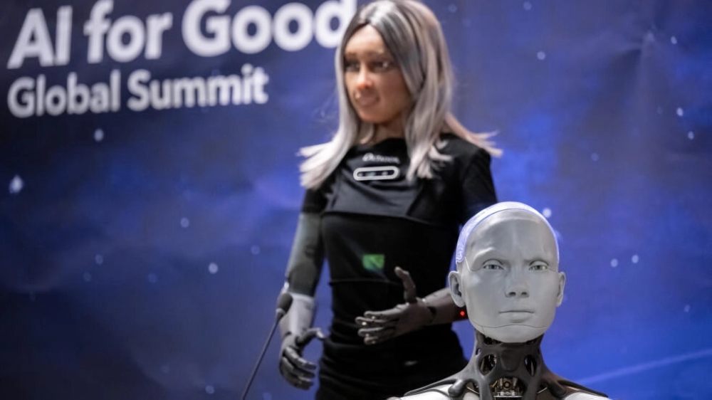 Humanoid social robots Mika and Ameca fielded questions at the AI for Good Global Summit press conference © Fabrice COFFRINI / AFP