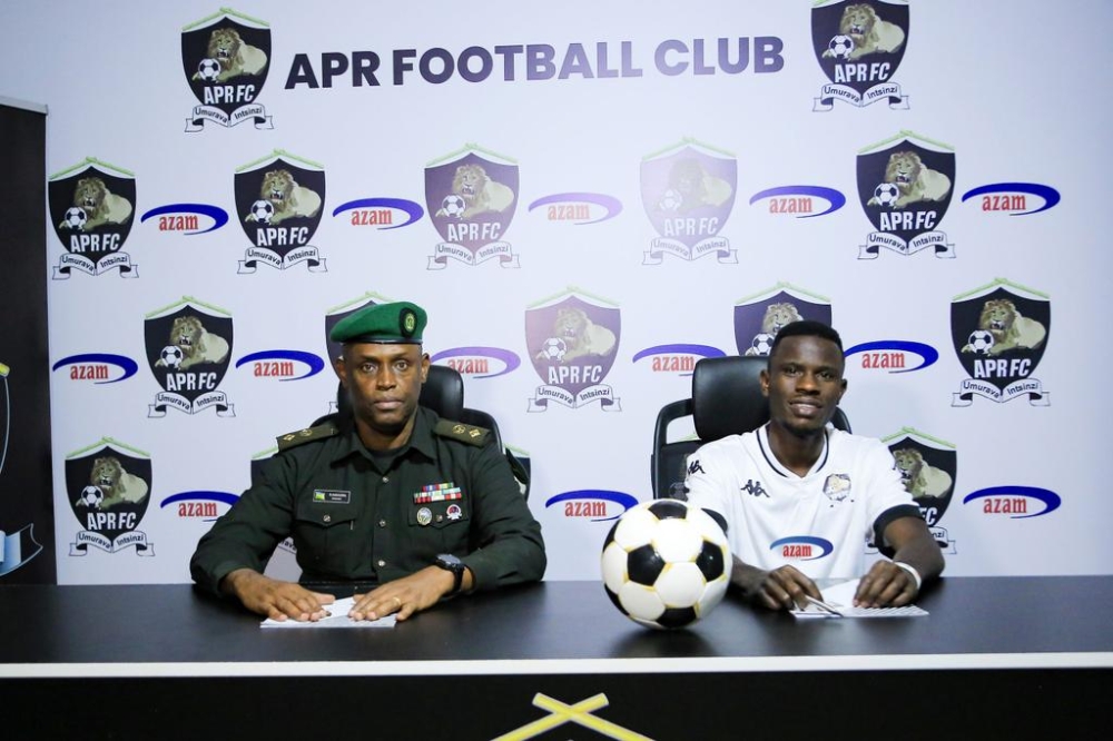 APR chairman Lt Col Charles Karasira and Burundian 
 international midfielder Ismail ‘Pitchou’ Nshimirimana during the signing of the deal to join the Army side. Courtesy