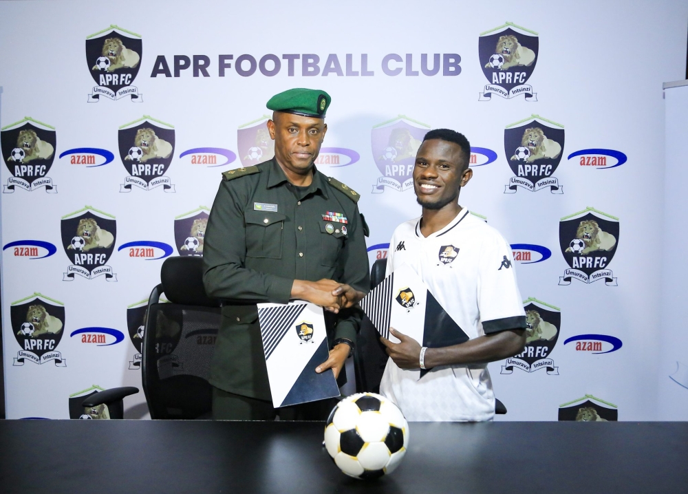 APR chairman Lt Col Charles Karasira and Burundian 
 international midfielder Ismail ‘Pitchou’ Nshimirimana during the signing of the deal to join APR FC. Courtesy
