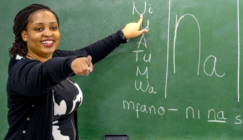 A Swahili teacher for beginners during a class. The name Swahili derives from the Arabic word sahil, meaning coast. Kiswahili emerged as a trade language along the East African coastline.