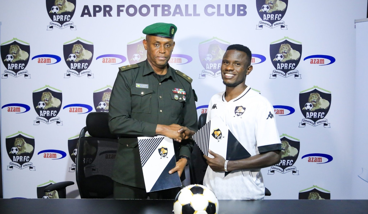 APR chairman Lt Col Charles Karasira and Burundian 
 international midfielder Ismail ‘Pitchou’ Nshimirimana during the signing of the deal to join APR FC. Courtesy
