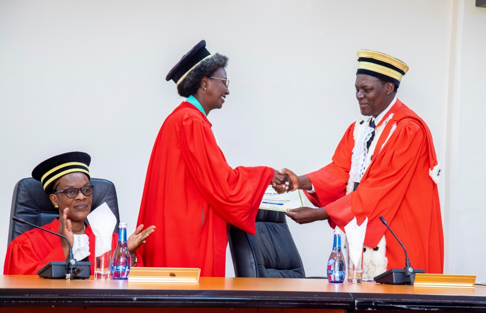 Chief Justice, Faustin Ntezilyayo hands over a certificate of appreciation to Justice Immaculee Nyirinkwaya during the event that took place at the Supreme Court  on Friday, July 7. COURTESY PHOTOS