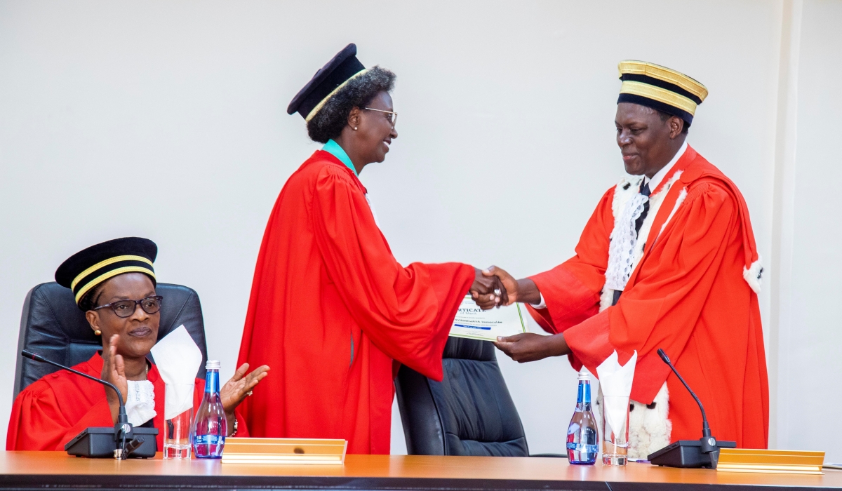 Chief Justice, Faustin Ntezilyayo hands over a certificate of appreciation to Justice Immaculee Nyirinkwaya during the event that took place at the Supreme Court  on Friday, July 7. COURTESY PHOTOS