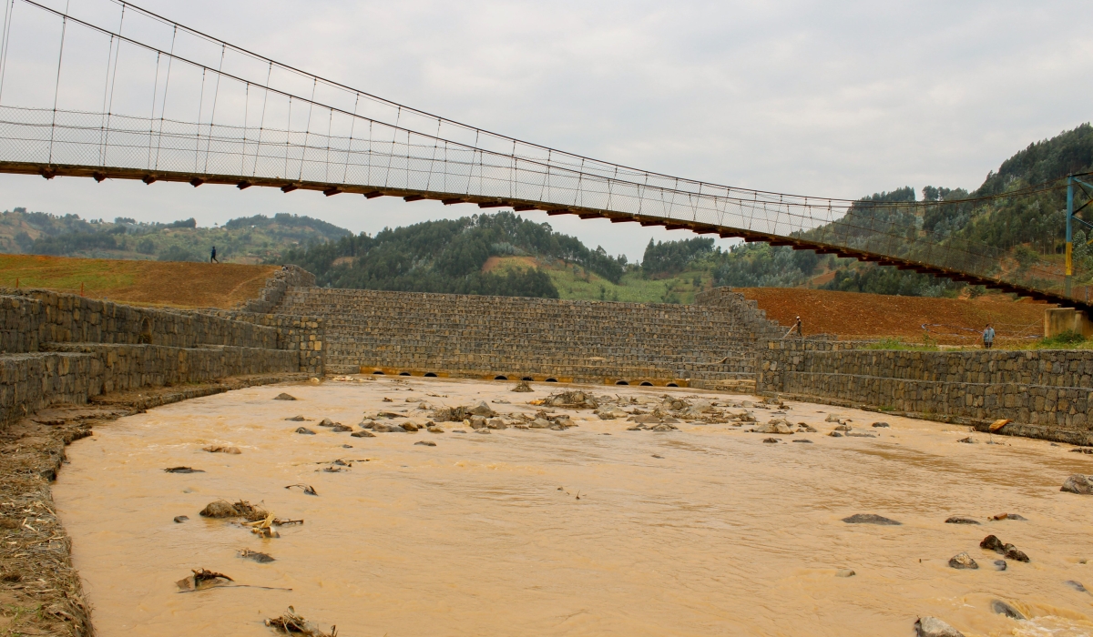 The newly constructed dam will serve to retain a portion of the floodwater and release it at a controlled flow rate.
