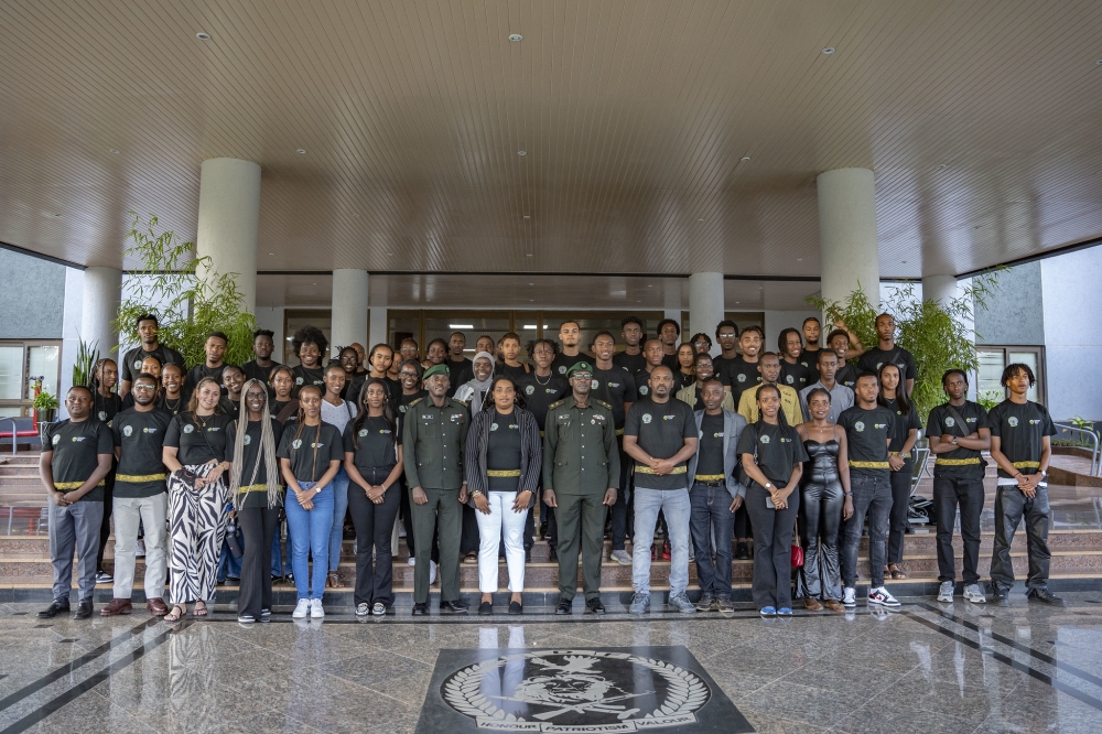 The Chief of Civil-Military Cooperation at the Rwanda Defence Force (RDF), Lt. Col. Vincent Mugisha poses for a photo with 65 diaspora youth participating in the Rwanda Youth Tour 2023 after a session at RDF headquarters.