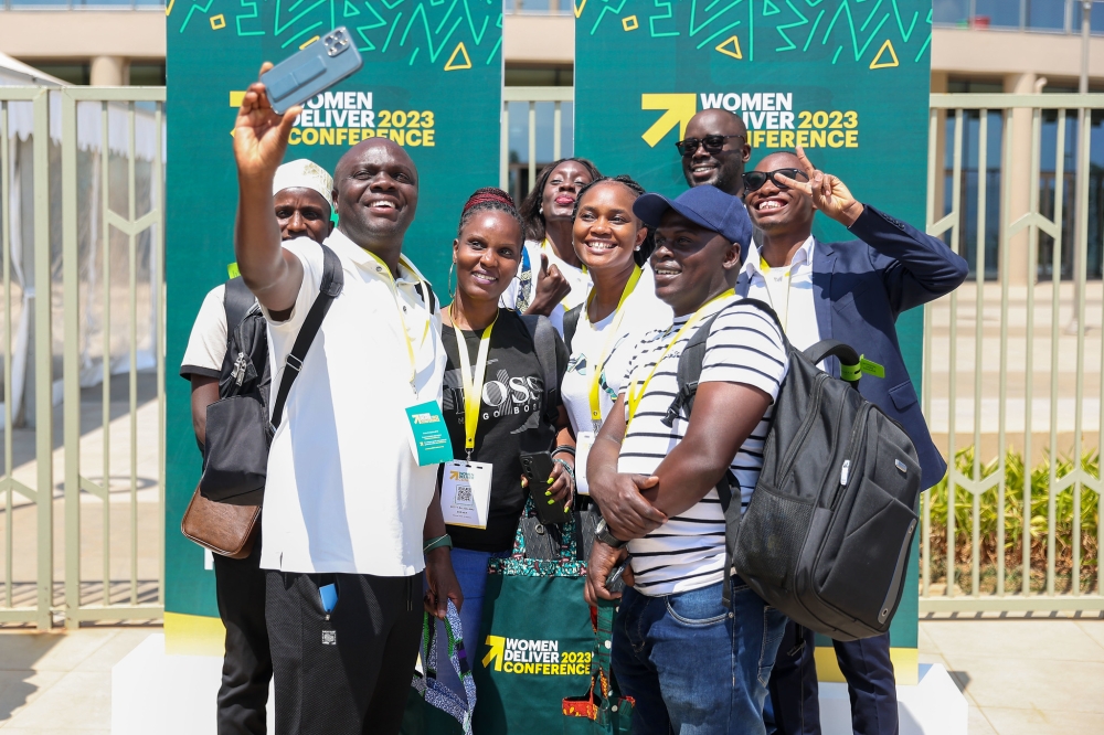 Some of over 6000 delegates expected to attend the 2023 Women Deliver Conference in Kigali. Seen here take pictures after receiving their badges on Saturday, July 15.