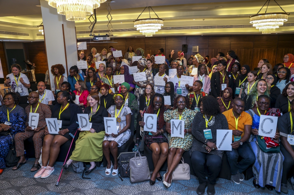 Delegates pose for a group photo at  a pre-conference focused on ending Female Genital Mutilation/Cutting (FGM/C) on Sunday July 16. Photos by Olivier Mugwiza
