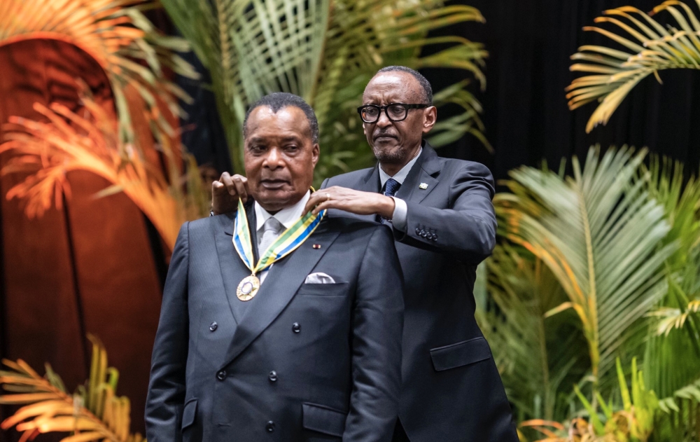President Paul Kagame decorating President Denis Sassou-Nguesso with the National Order of Honor (Agaciro) medal.
