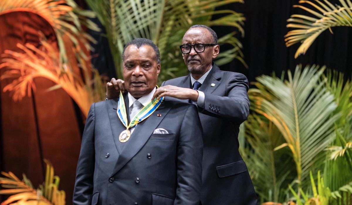 President Paul Kagame decorating President Denis Sassou-Nguesso with the National Order of Honor (Agaciro) medal.