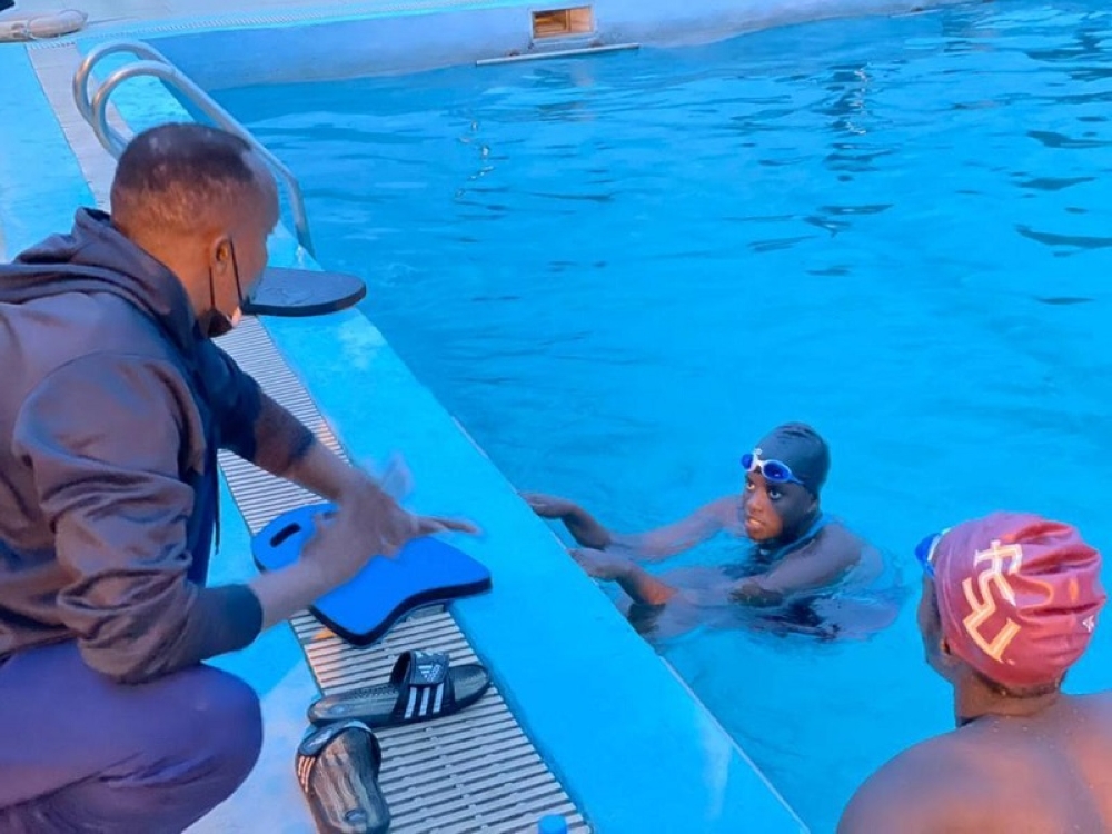 Rwandan swimmer Claudette Ishimwe listens to the coach&#039;s instructions during a training session. Ishimwe and Niyibizi on Sunday, head to Japan for the forthcoming World Aquatics championships.