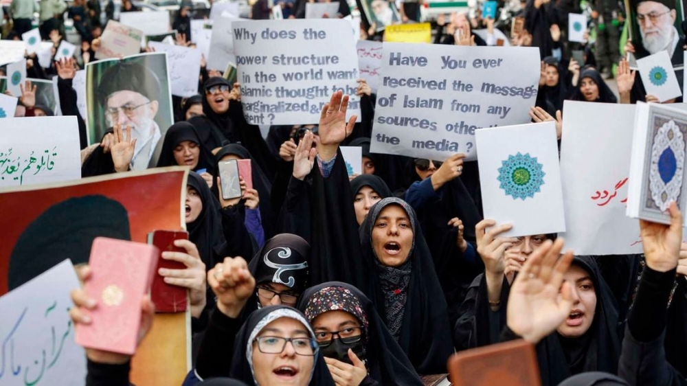Students lift placards and chant slogans during a demonstration denouncing the burning of the Quran in Sweden, Islam&#039;s holy book, in front of Swedish embassy in Tehran, Iran on July 21. PHOTO: AFP