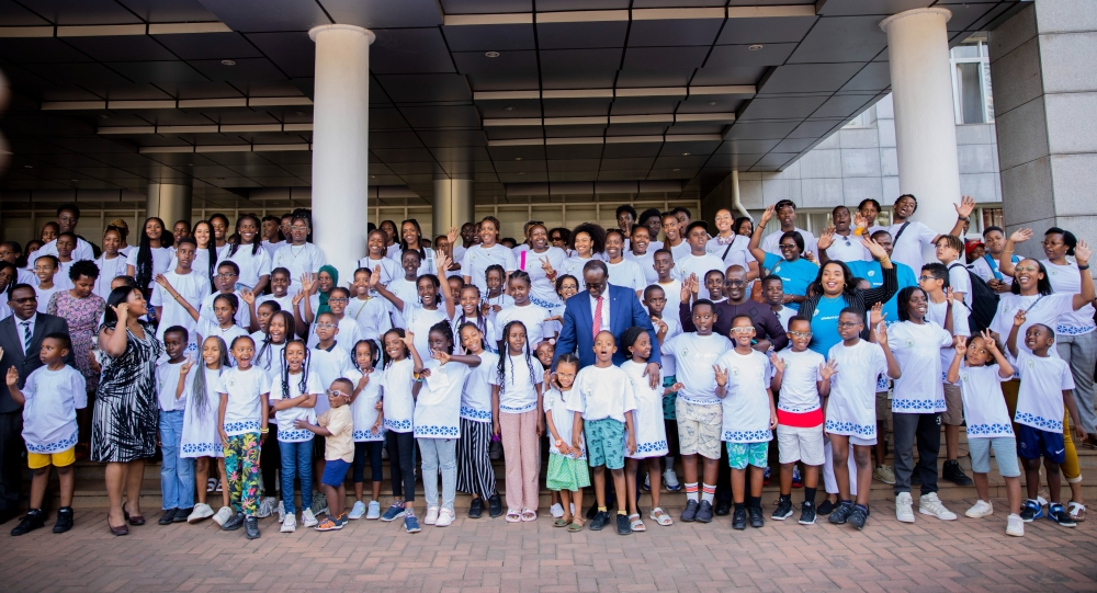 Minister of State in the Foreign Affairs Ministry, Manasseh Nshuti poses for a group photo with Rwandan youth and children from diaspora, accompanied by their parents during a visit to Rwanda to learn Rwandan culture, in Kigali on July 25. The group of 140 people is composed of children from Belgium, England and Switzerland .  Courtesy
