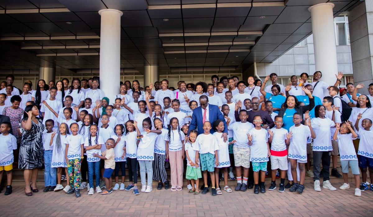 Minister of State in the Foreign Affairs Ministry, Manasseh Nshuti poses for a group photo with Rwandan youth and children from diaspora, accompanied by their parents during a visit to Rwanda to learn Rwandan culture, in Kigali on July 25. The group of 140 people is composed of children from Belgium, England and Switzerland .  Courtesy
