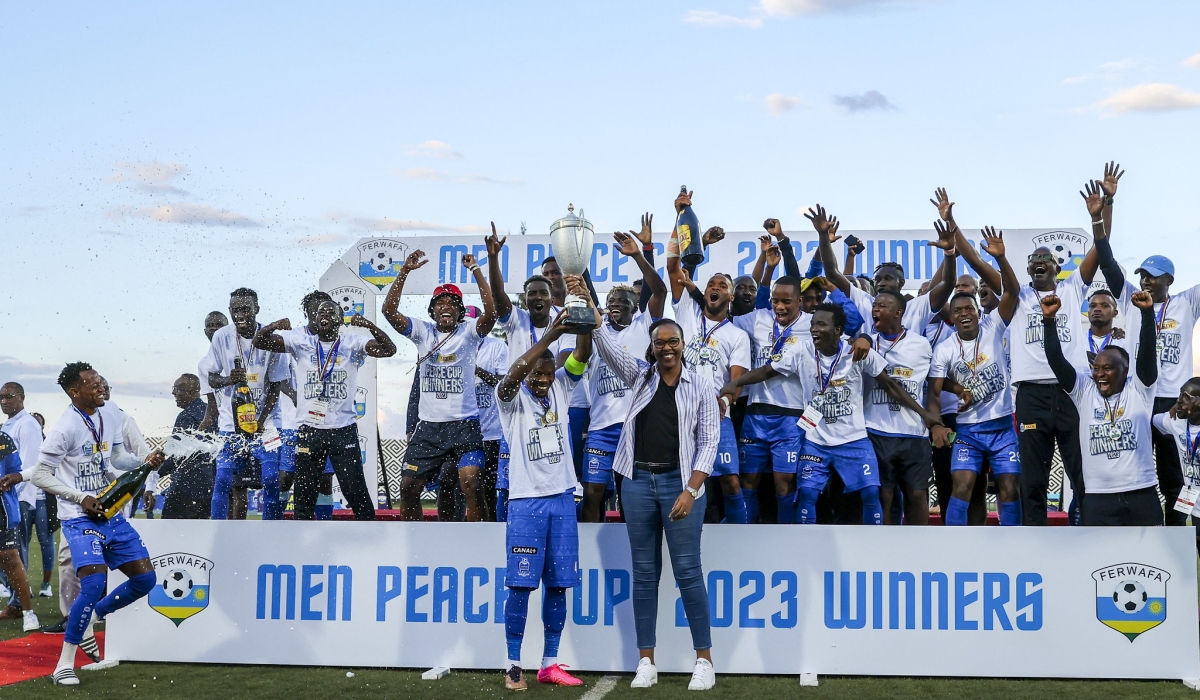 Minister of Sports Mimosa Munyangaju hands over the trophy to Rayon Sports skipper as they win the 2023 Peace Cup title at Huye stadium. Rayon Sports will not play the first preliminary round of the 202324 CAF Confederation Cup. Photos by Olivier Mugwiza