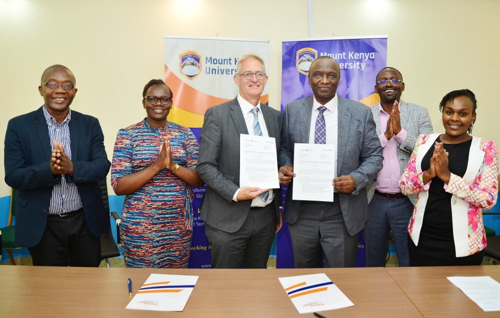 The MKU Vice-Chancellor Prof. Deogratius Jaganyi (third from left) and Georg Willet, the Vice-President of Lebenshilfe Tirol, show the letter of intent shortly after signing. The signing was witnessed by MKU staff and a member of TYE Pathways Ltd. Courtesy. 