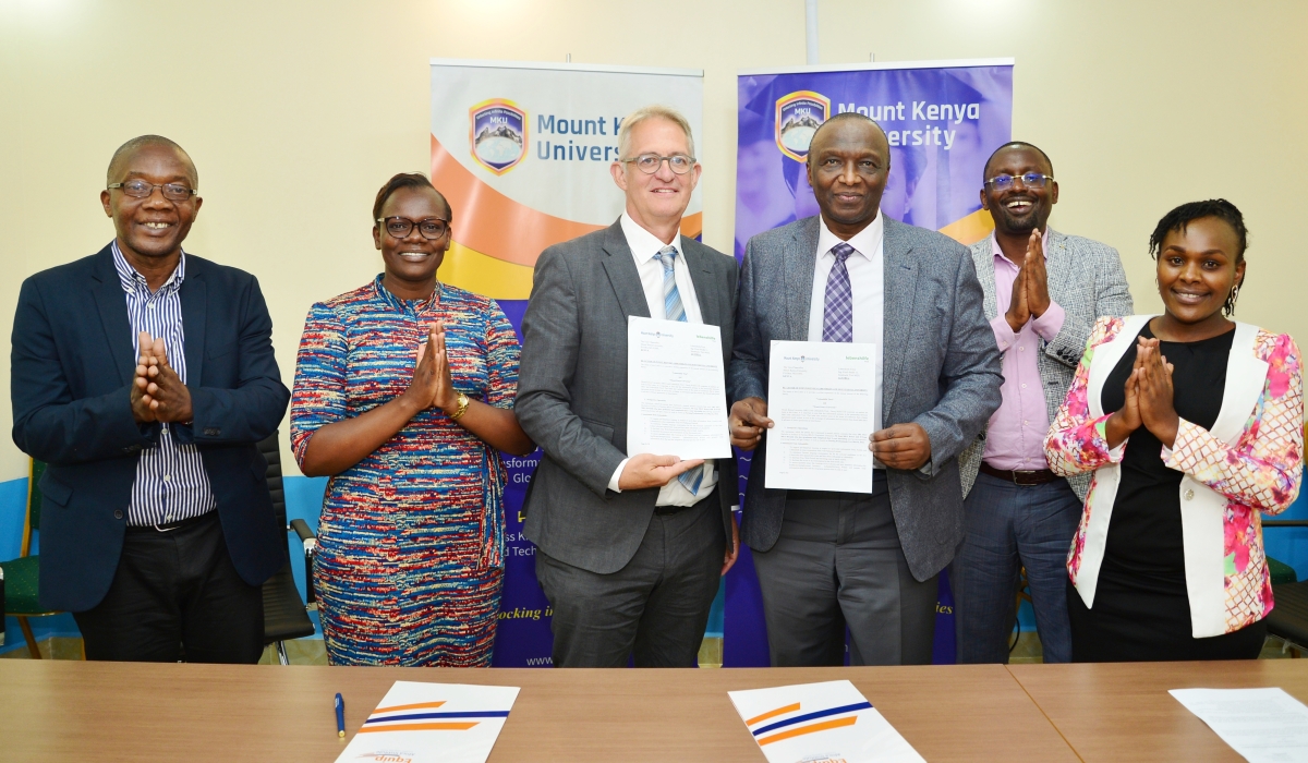 The MKU Vice-Chancellor Prof. Deogratius Jaganyi (third from left) and Georg Willet, the Vice-President of Lebenshilfe Tirol, show the letter of intent shortly after signing. The signing was witnessed by MKU staff and a member of TYE Pathways Ltd. Courtesy. 