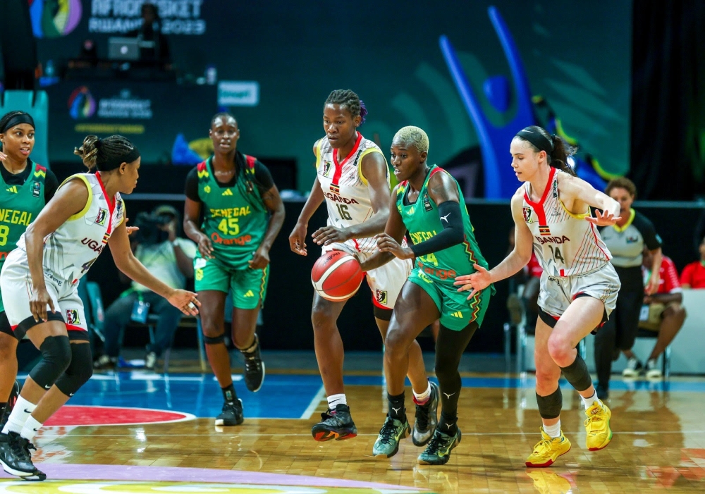 Ugandan players put pressure on a Senegalese opponent a she tries to dribble towards Ugandan paint. Gazelles beat Senegal 85-83-Photos by Olivier Mugwiza