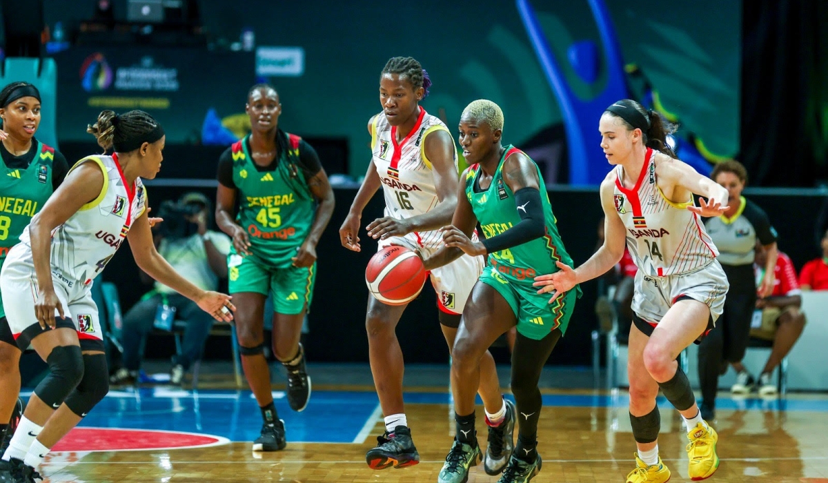 Ugandan players put pressure on a Senegalese opponent a she tries to dribble towards Ugandan paint. Gazelles beat Senegal 85-83-Photos by Olivier Mugwiza