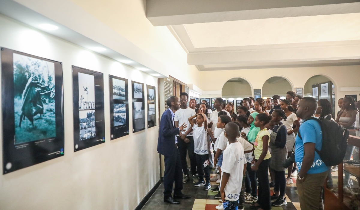 A group of 140 diaspora youth and children follow a museum guide as he explains certain events in Rwanda&#039;s history. All photos by Dan Gatsinzi