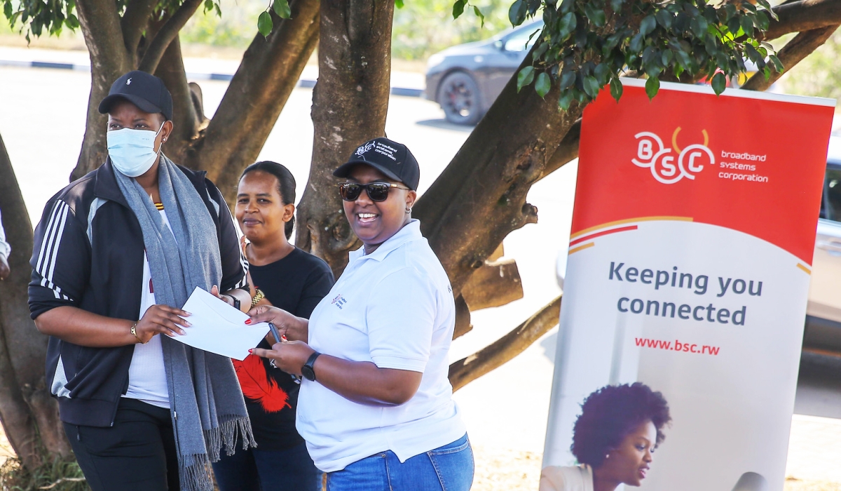 Susan Mutesi, the Chief Shared Services at BSC, hands over a cheque to Susan Mukasano, the Executive Secretary of Gikondo Sector, to pay  health insurance (Mutuelle de Sante)  to 1,500 people in Kinunga cell, Gikondo Sector, Kicukiro on July 29. Craish Bahizi