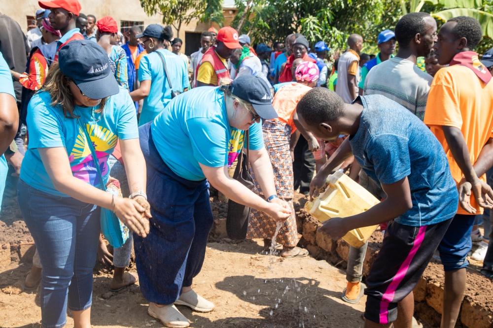 Jocelyn Wyatt, the Chief Executive Officer of Alight (R) washes her hands after contributing at community work. All photos by Craish Bahizi