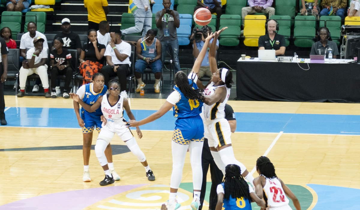 Rwanda and Angolan players jump high as they battle for a ball during Sunday&#039;s Group A clash. Rwanda lost 68-74 to Angola but advanced to the quarter finals of the ongoing FIBA Women&#039;s Afrobasket. PHOTOS BY CHRISTIANNE MURENGERANTWARI