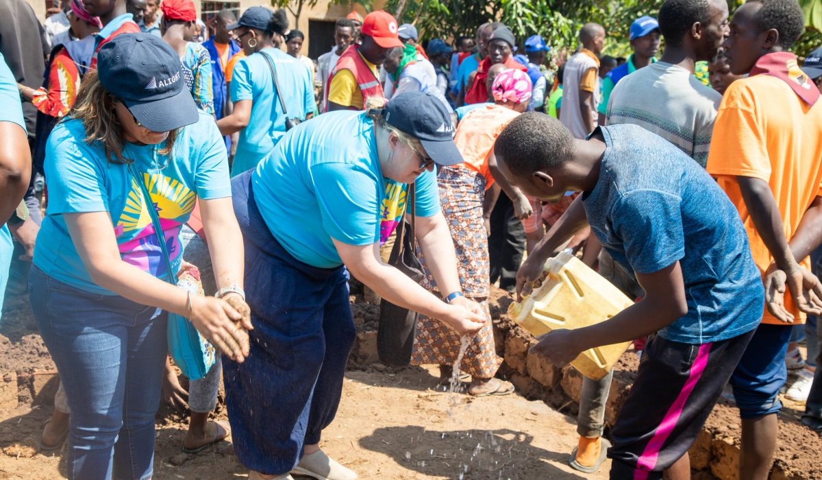 Jocelyn Wyatt, the Chief Executive Officer of Alight (R) washes her hands after contributing at community work. All photos by Craish Bahizi