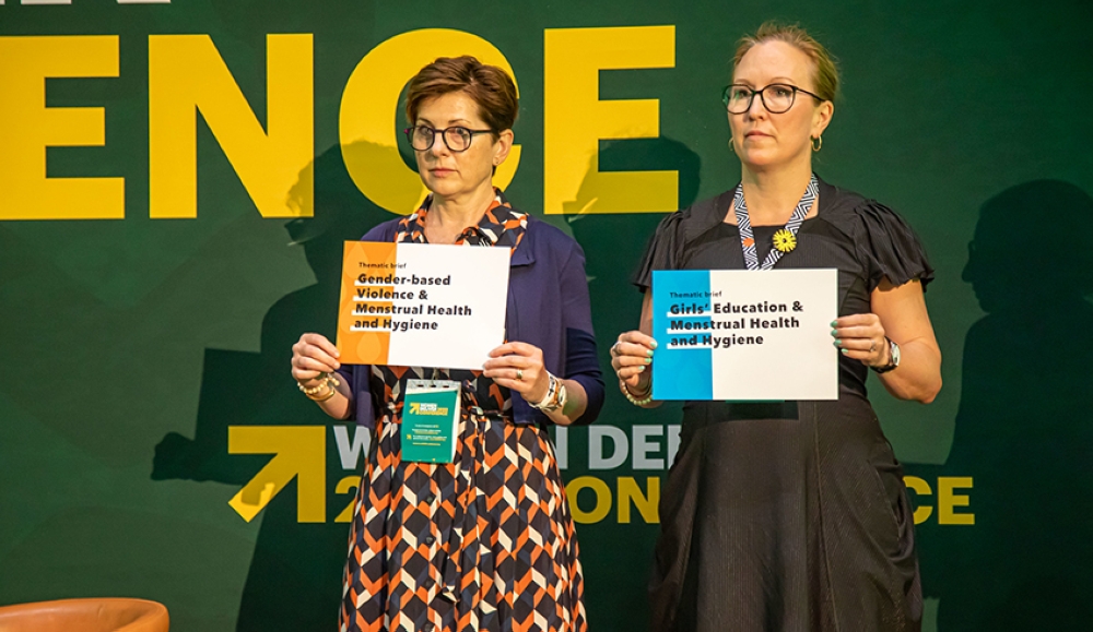 Some delegates hold some messages for gender equality during Women Deliver Conference in Kigali. Photo by Olivier Mugwiza