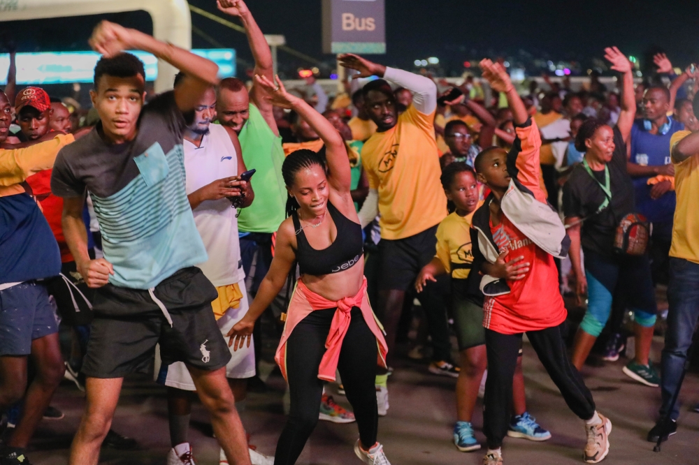 Kigali residents stretch, at BK Arena, before taking part in Kigali Night Run in June last year. Photo: Craish Bahizi.