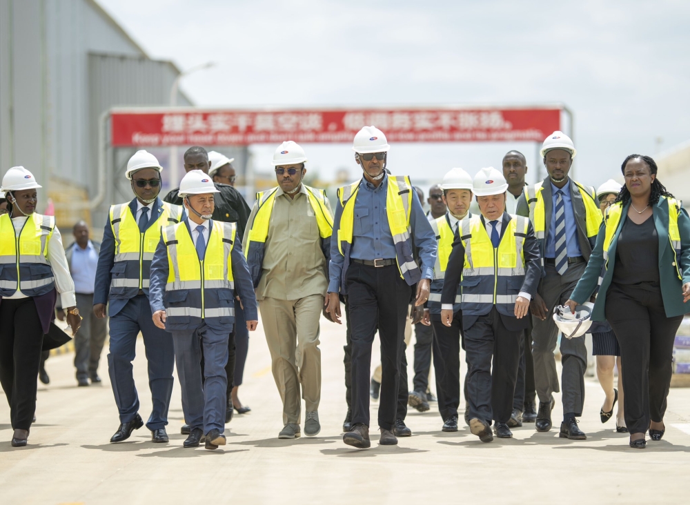 President Paul Kagame with delegates during a guided tour of the newly inaugurated Anjia Cement Factory in Muhanga
District,on Thursday, August 3. The $100 million firm employs 205 staff, with plans to go up to 250 by the end of the year. In
his remarks, Kagame called for enabling investment policies, to attract major impactful investments in Africa. Photo: Village
Urugwiro.