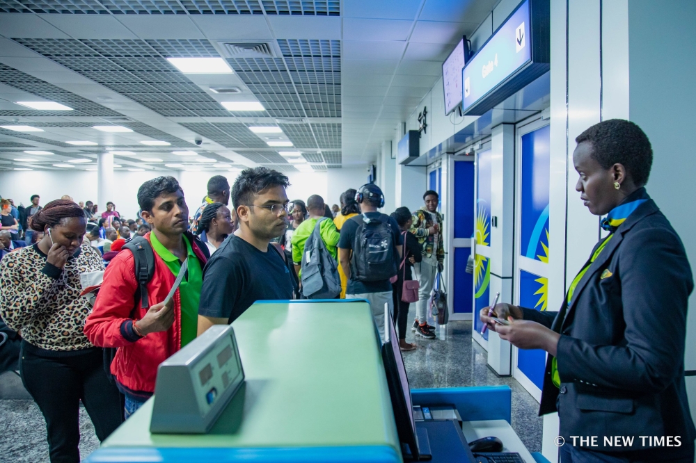 RwandAir&#039;s staff checks the authenticity of travel documents before boarding a  plane at Kigali International Airport on June 18, 2019 . Sam Ngendahimana